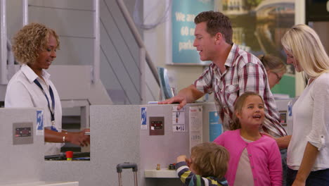 family going on vacation checking in at airport shot on r3d