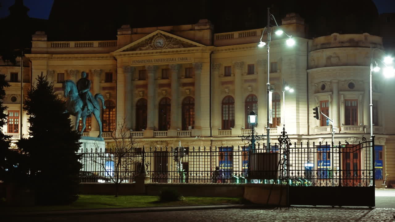 Bucharest, Romania - December 21, 2021: People walking in front of the Central University Library Carol I in the evening