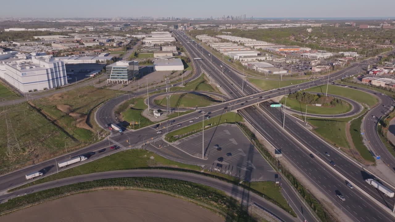 Highway 401 interchange in mississauga, showing industrial buildings and traffic, aerial view