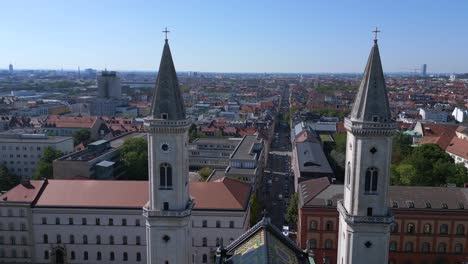 Smooth-aerial-top-view-flight-Church-roof-St-Ludwig-City-town-Munich-Germany-Bavarian,-summer-sunny-blue-sky-day-23