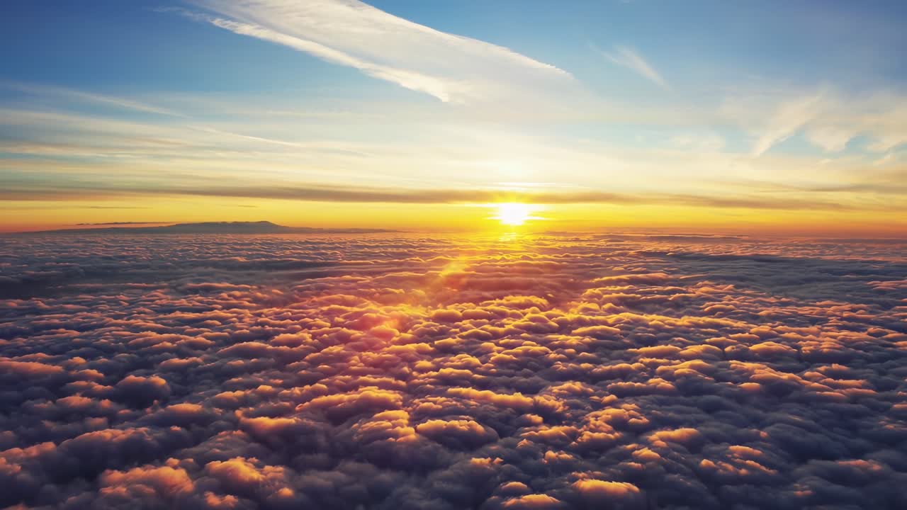 Vídeo aéreo de um nascer do sol deslumbrante sobre nuvens fofas, capturando uma vista serena e expansiva