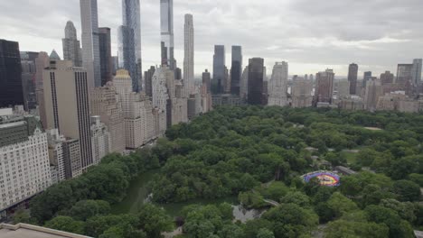 aerial view of the central park and skyscrapers in midtown, nyc, usa - panning, tilt, drone shot