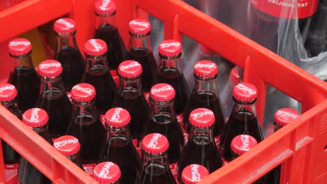 coca-cola bottles in a red crate