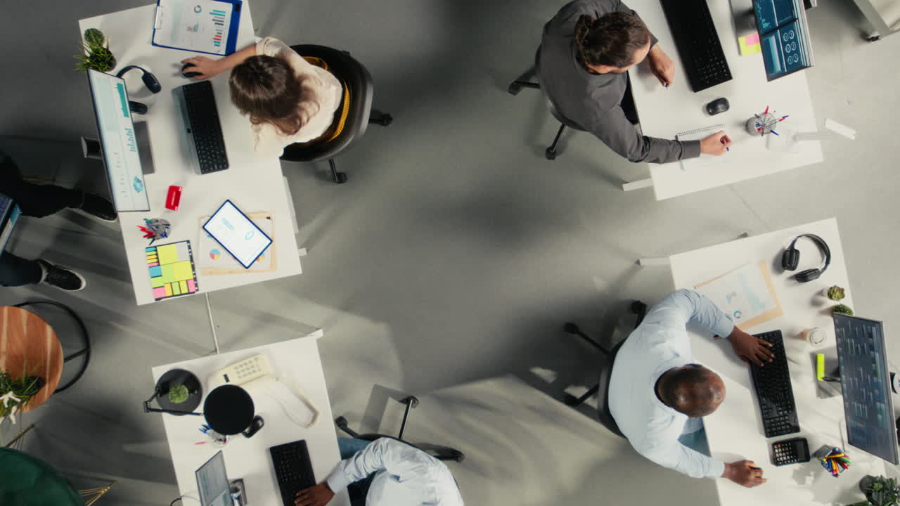 Vertical Video Top down view zoom in of corporate coworkers engaged in task management
