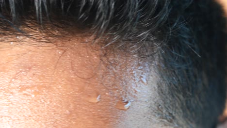 close-up of a person's forehead with sweat