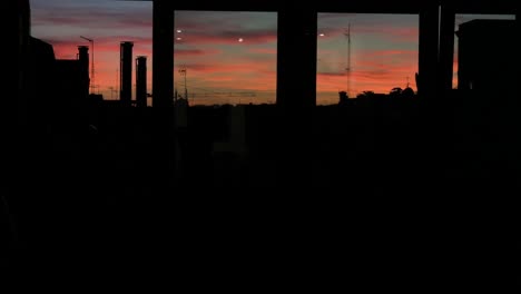 A-see-through-home-window-view-of-a-beautiful-soft-color-palette-Summer-sunset-and-sky-seen-in-downtown-Madrid,-Spain