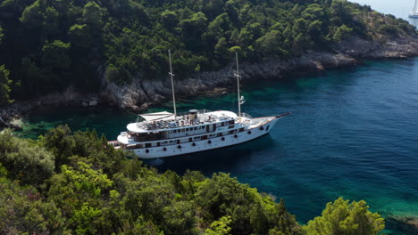 Big-Ferry-Anchored-In-A-Cove-In-Peljesac-Croatia---aerial-shot