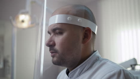 close-up of a medical professional wearing a face shield