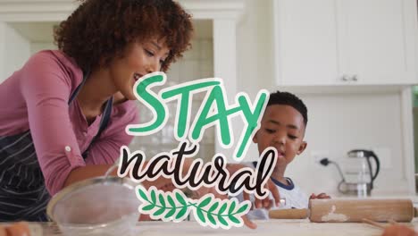 Animation-of-stay-natural-text-over-happy-african-american-mother-and-son-cooking-at-home