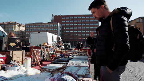 people browsing a busy outdoor market in a city