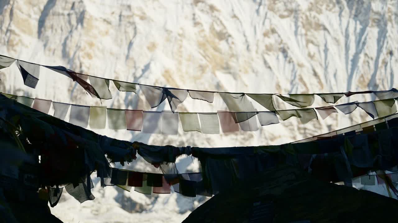 Close Up Prayer Flags in Snowy Mountains in Nepal, Colorful Tibetan Prayer Flags on Blue Sky Sunny Day in the Snowcapped Himalayas in Annapurna, Colourful Buddhism Flags in Nature