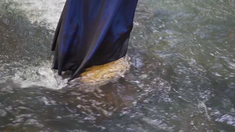 A-girl-standing-on-the-river-in-the-Salto-Encantado-park-located-in-Misiones,-Argentina