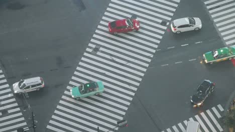 High-Angle-Top-Down-Super-Long-Tele-Shot-of-Traffics-and-Pedestrians-at-the-Famous-Shibuya-Crossing-at-Night-in-Shibuya-During-the-Pandemic,-Hyperlapse