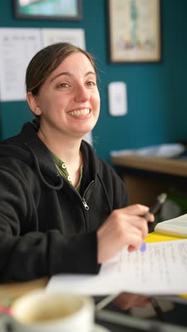 woman writing at desk