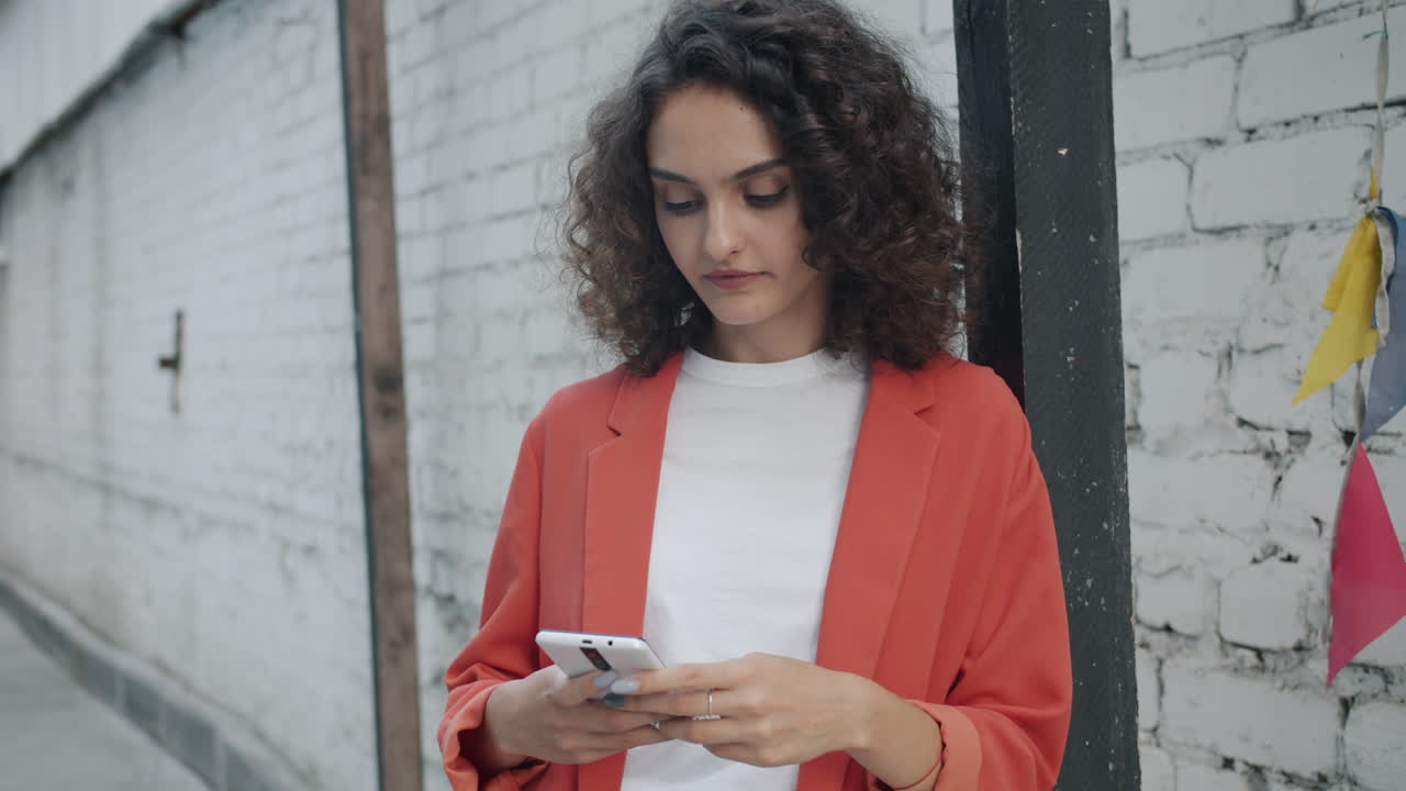 Young Woman Texting on Smartphone in City