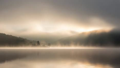 a serene morning fog over tranquil waters: capturing the ethereal beauty of nature as mist gently lifts from the calm lake surrounded by mountains