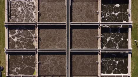 Aerial-view-above-different-chambers-of-water-being-treated-at-water-treatment-plant