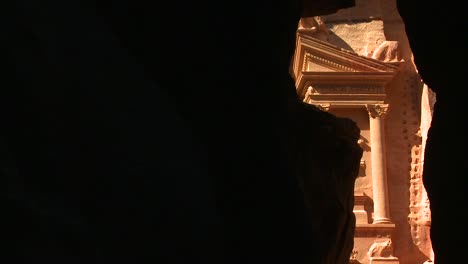 view of the facade of the treasury building in the ancient nabatean ruins of petra jordan through the narrow canyon entrance 2