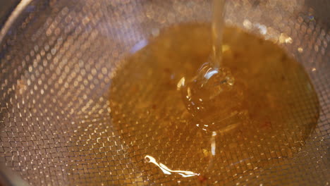 golden honey strained through strainer