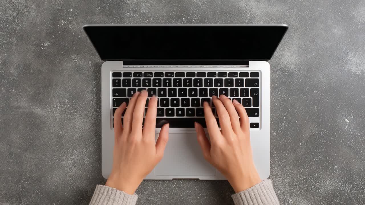 A Close-Up View of Hands Typing on a Laptop Keyboard, Showcasing Focused Work and Digital Engagement in a Modern Workspace Environment