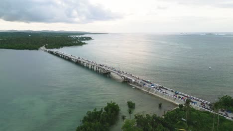 Aerial-reveal-of-Siargao-Catangnan-Bridge-and-reflection-on-turquoise-water