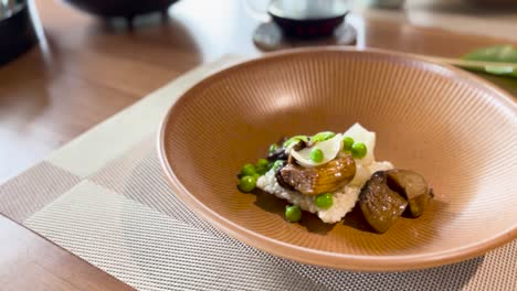 putting grated black truffle topping to a vegetable dish as garnish