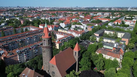 Nice-aerial-top-view-flight-Lukas-church-city-Berlin-steglitz,-Germany-Summer-day-2023