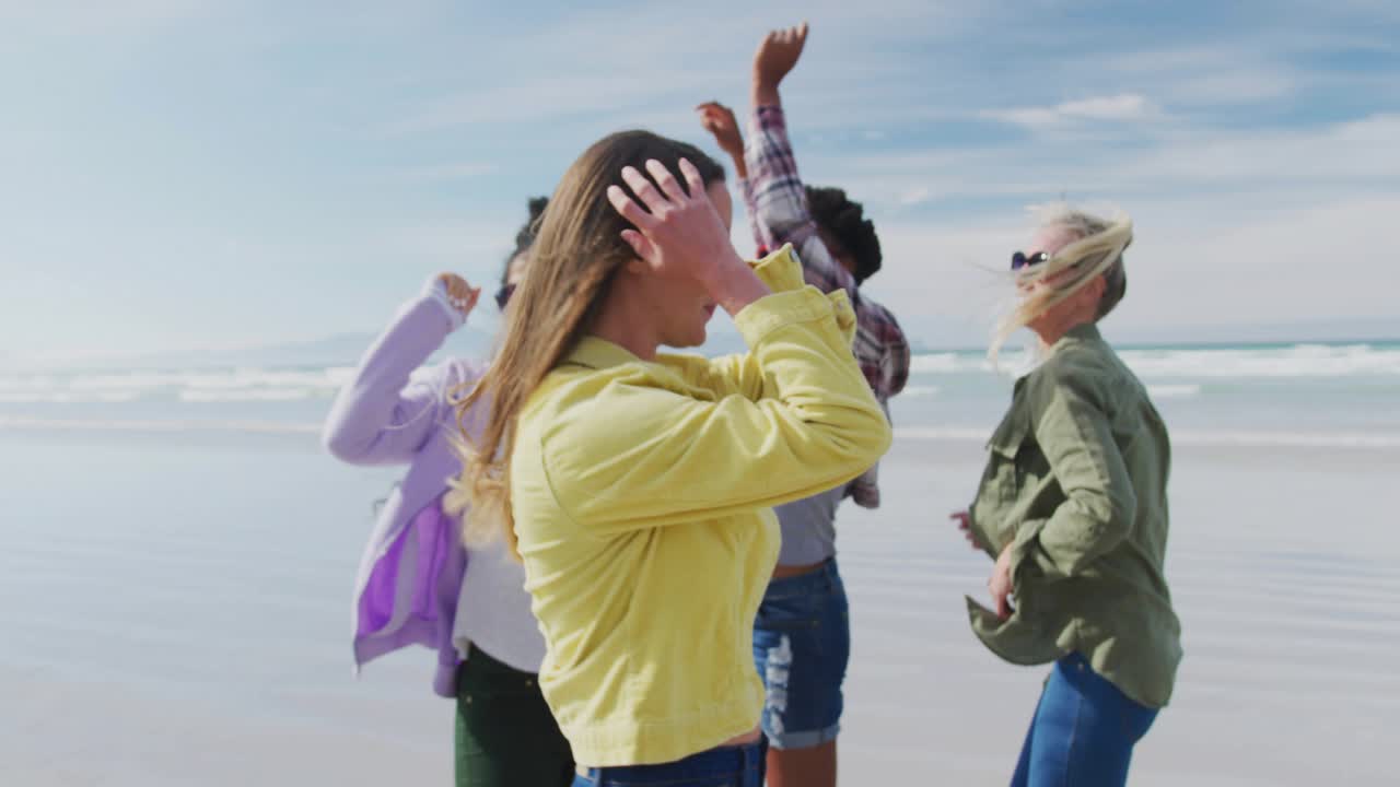 Front woman stepping adjusting red shades reaching lens moving blue panels on beach for content