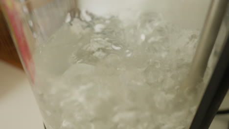 steaming water bubbles in a kettle for brewing tea or coffee in slow motion