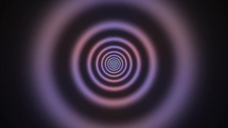 This visual features a spiral design with concentric circles filled with blue and purple hues. The pattern creates a sense of depth and movement in a dark background