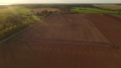 Sowing-fields-with-tractor-and-seeder-in-dusty-field-aerial-view