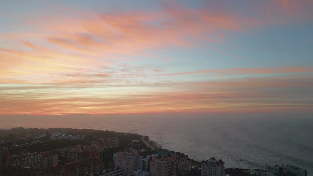 Sunrise sky lit town placed on  shoreline. Amazing orange skyline