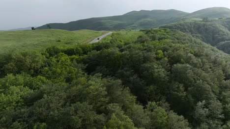 Dolly-in-aerial-shot-following-a-car-driving-on-the-road-in-the-Didgori-Valley