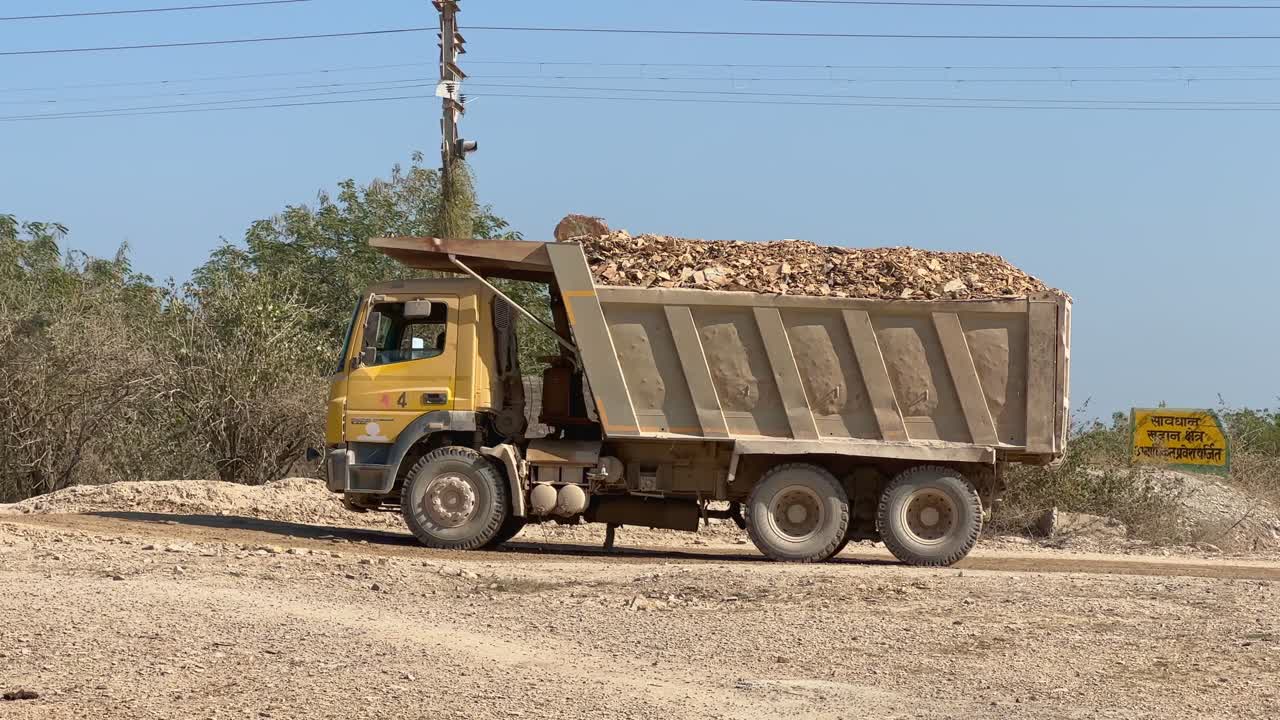 A truck load of iron ore or raw material being carried away on Hyva trucks, these hyva used in a variety of industries, including construction, mining, transportation, and agriculture.