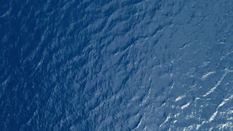drone top down bird's eye view of ripples in caribbean ocean water as currents flow