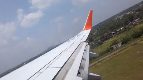 airplane wings take off in airstrip revealing kuala lumpur malaysia capital