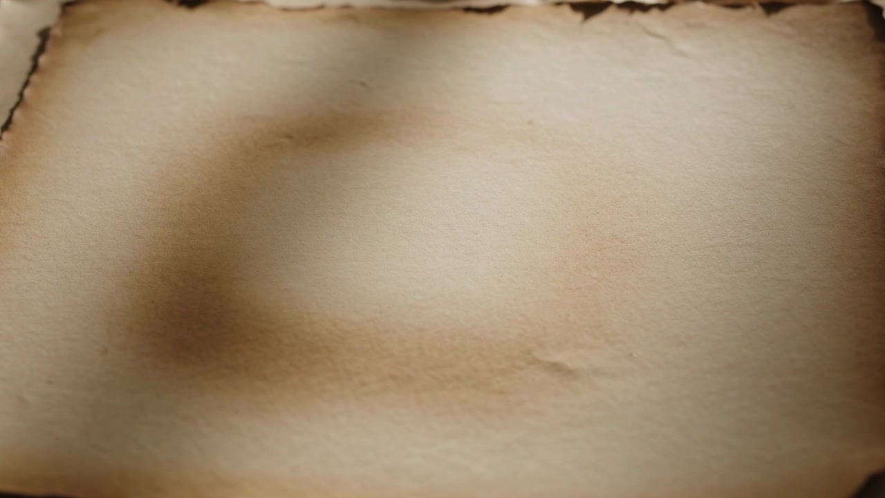 Shifting soft directional light casting shadow across aged parchment on table, revealing texture