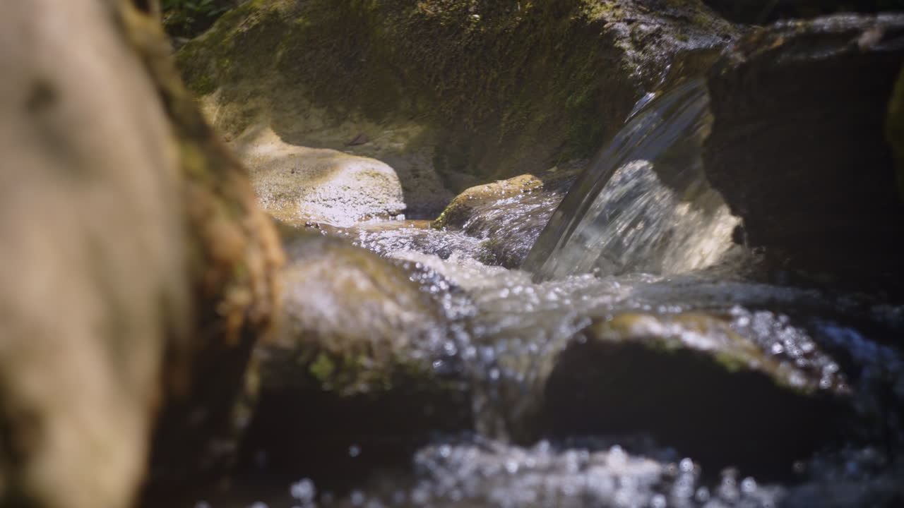 Waterfall flowing over mossy rocks