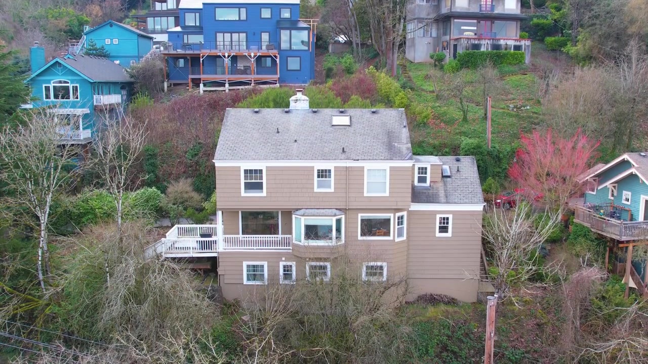 Rising drone shot looking down over a cozy home in the Pacific Northwest.
