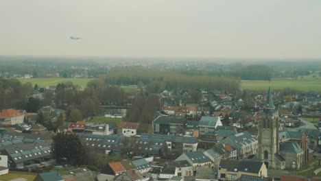 plane flies low and close over the municipality of steenokkerzeel direction brussels airport, belgium