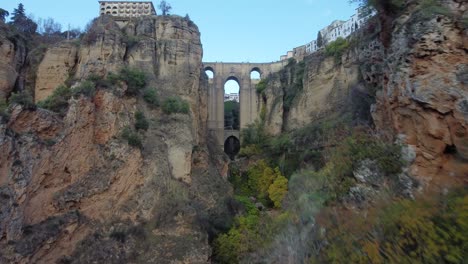 Rocky-cliff-landscape-with-Ronda-city-on-top-in-Spain,-aerial-view