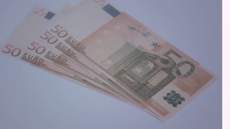 Animation-of-close-up-of-euro-bills-falling-against-grey-background