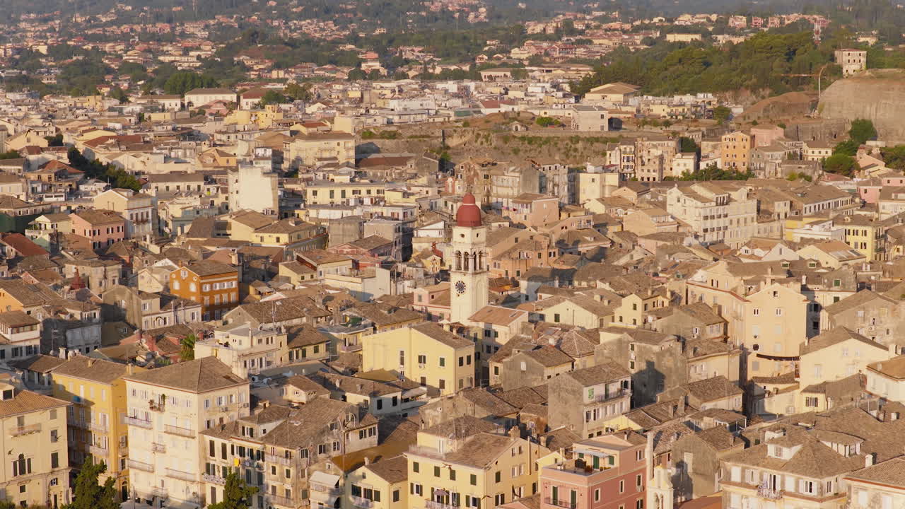 Panoramic drone video of Saint Spyridon Church in Corfu old town at sunrise, with swallows flying across the early morning sky
