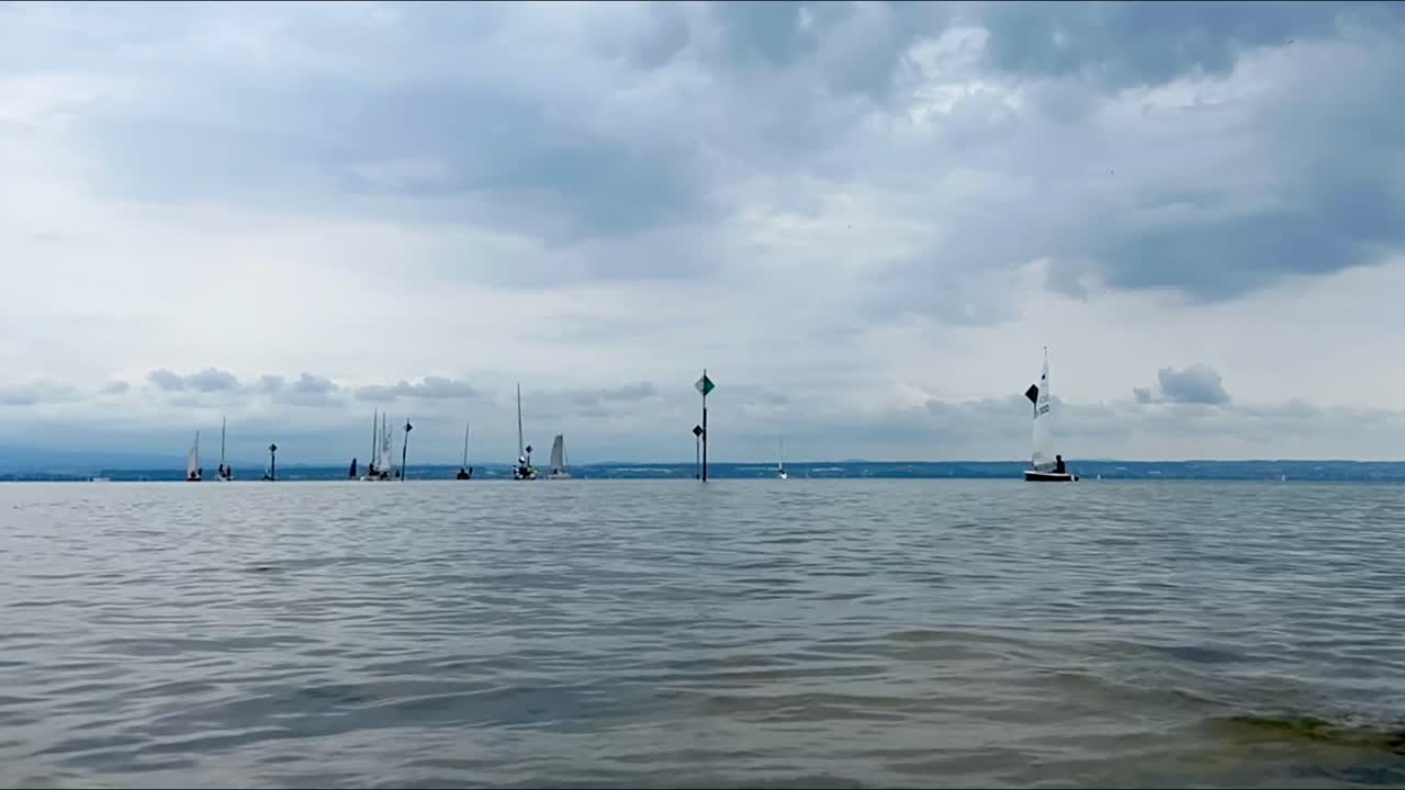 Time lapse of sailing ships leaving the port at the Bodensee lake in Bavaria in Germany