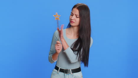 magician witch young woman gesturing with magic wand making wish come true, casting magician spell