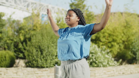 side view of african-american woman jumping in place in nature