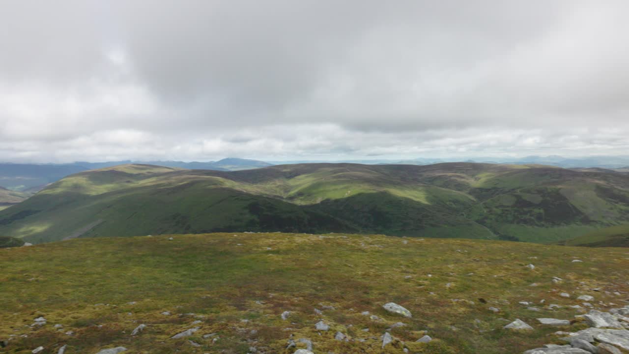 Slow establishing shot of a loch and hills from the Ben Chonzie summit