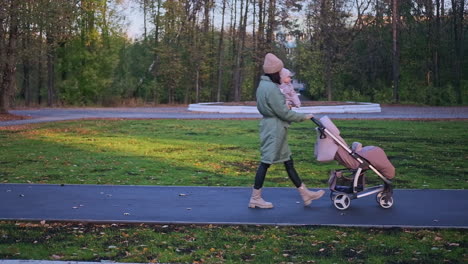 mother and child walking in an autumn park