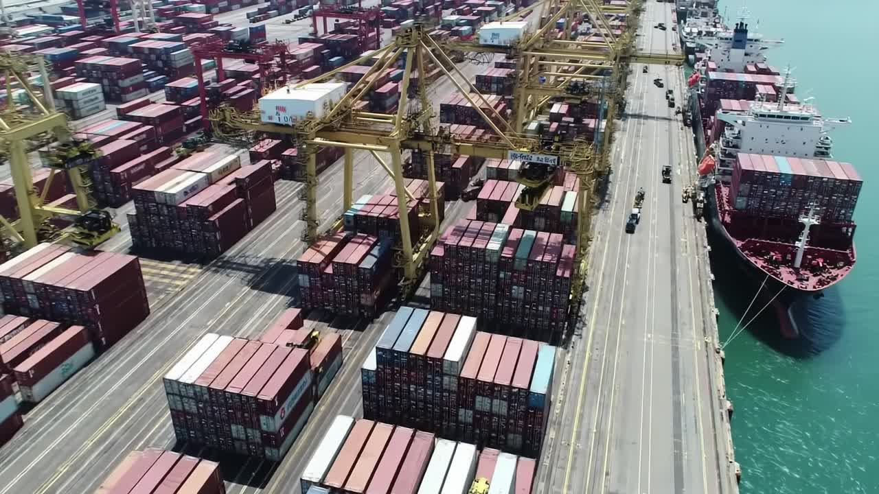 Aerial View of Container Port Operations: Efficient Handling of Cargo Crates and Ships in an Organized Harbor Environment