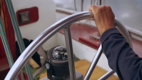 sailor is at the helm